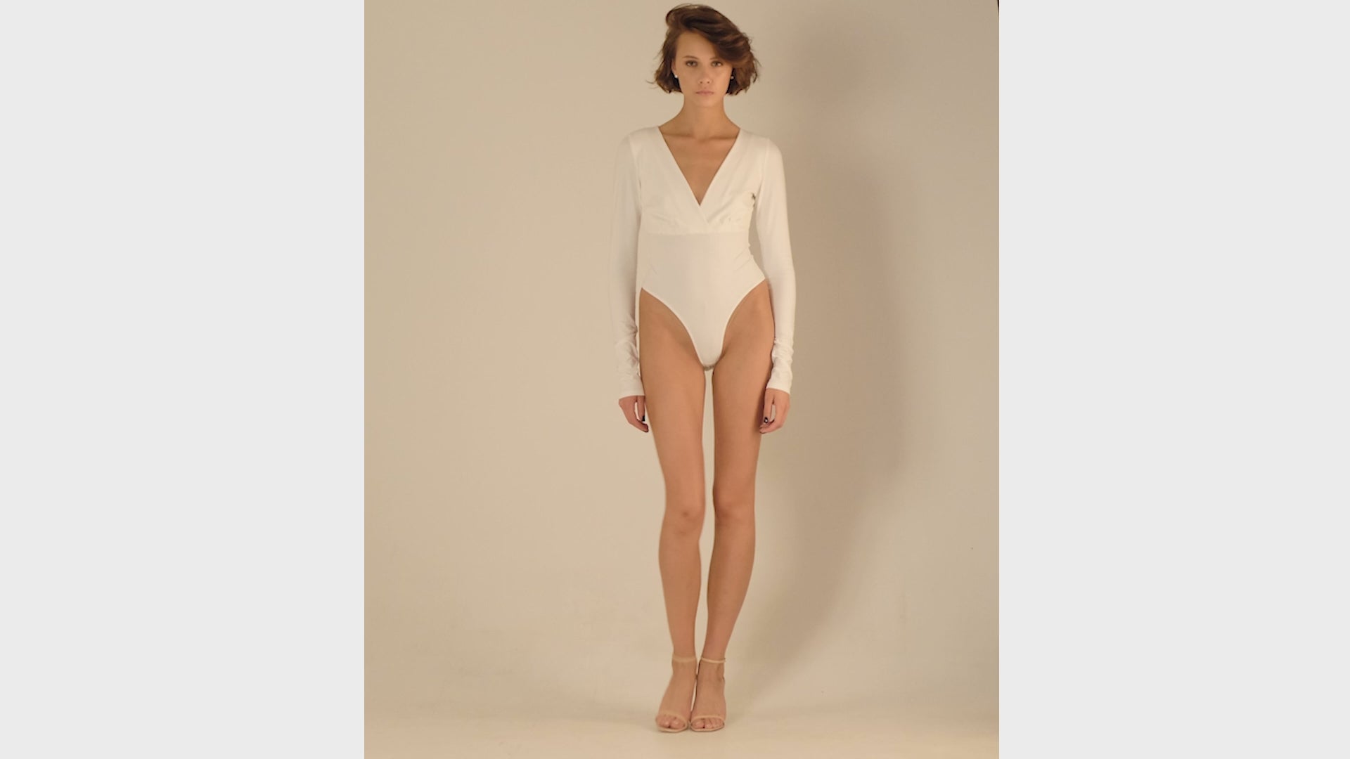 This bodysuit's model gives elegant sporty vibe. V-shape decollate and open back creates slightly provocative but very strong look.