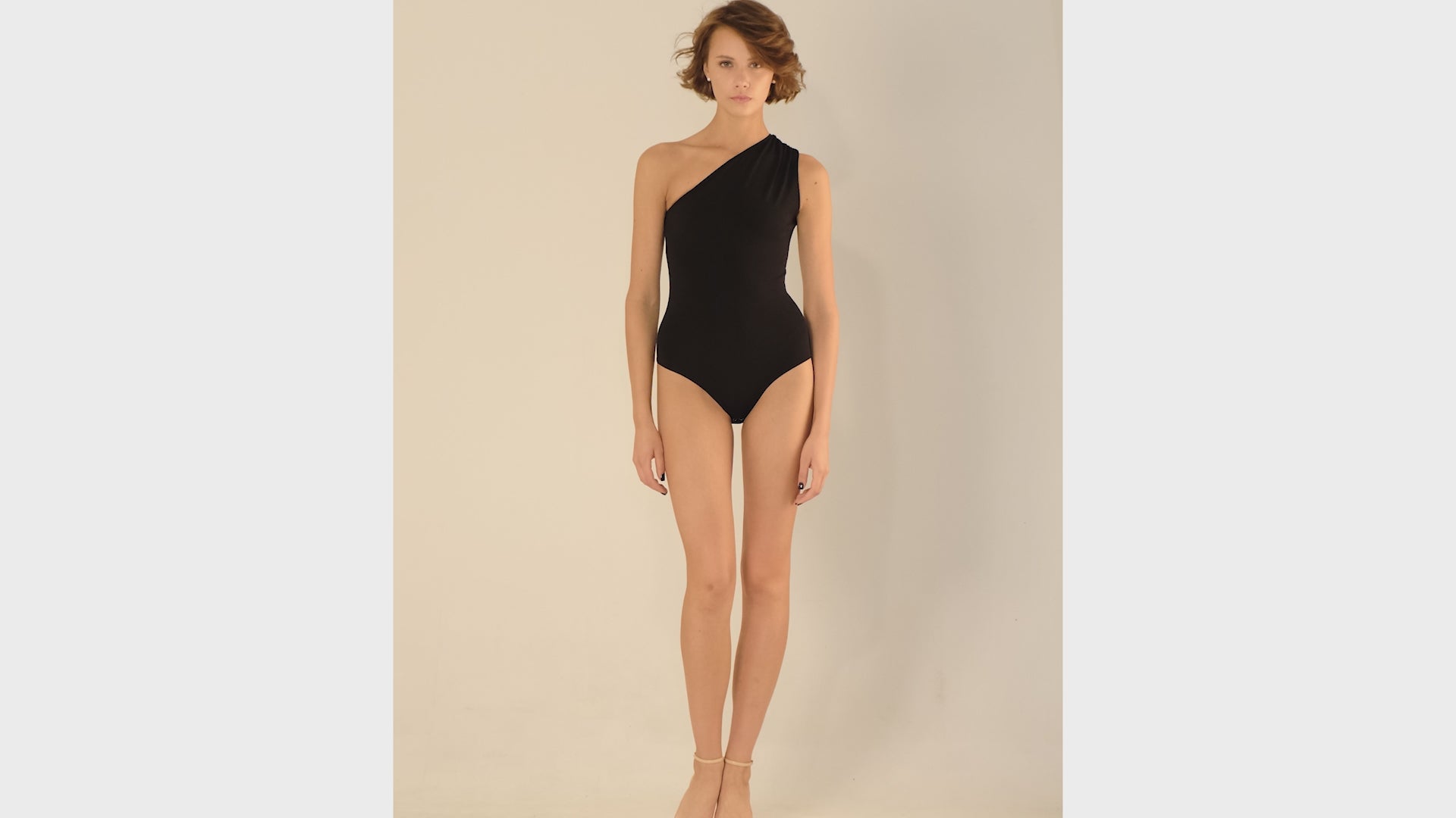 This bodysuit's model beautifully highlights the collarbone area and shows shoulders. Light shirring on the shoulder creates very refined look.