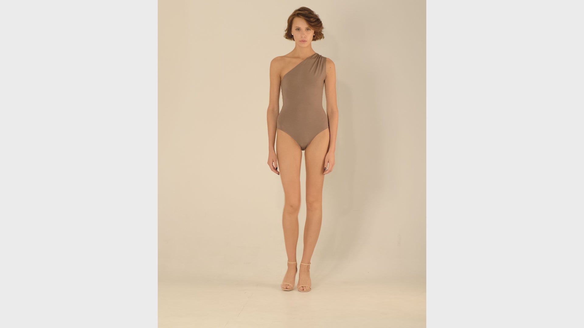 This bodysuit's model beautifully highlights the collarbone area and shows shoulders. Light shirring on the shoulder creates very refined look.