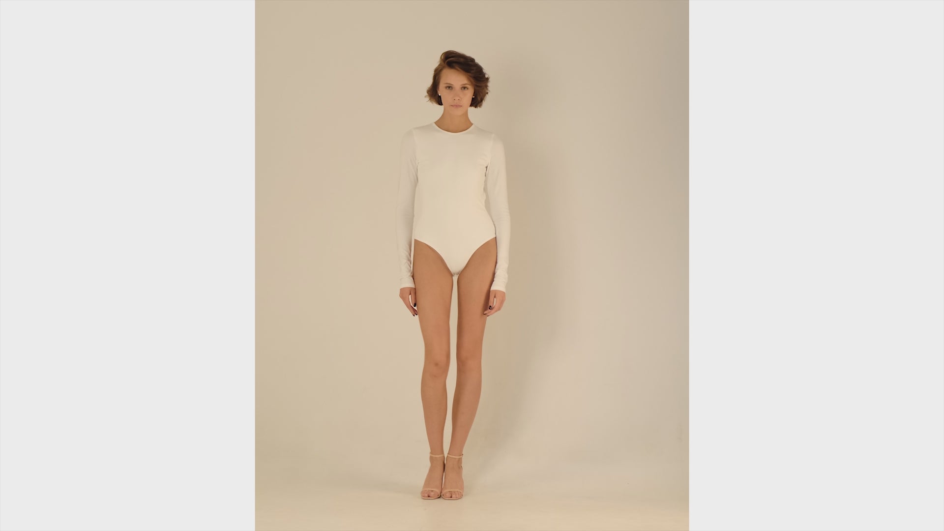 This bodysuit's model embraces femininity more than any piece of clothing possibly could. Non-transparent elastic fabric perfectly covers your body from the front and opens on the back flirtatiously.