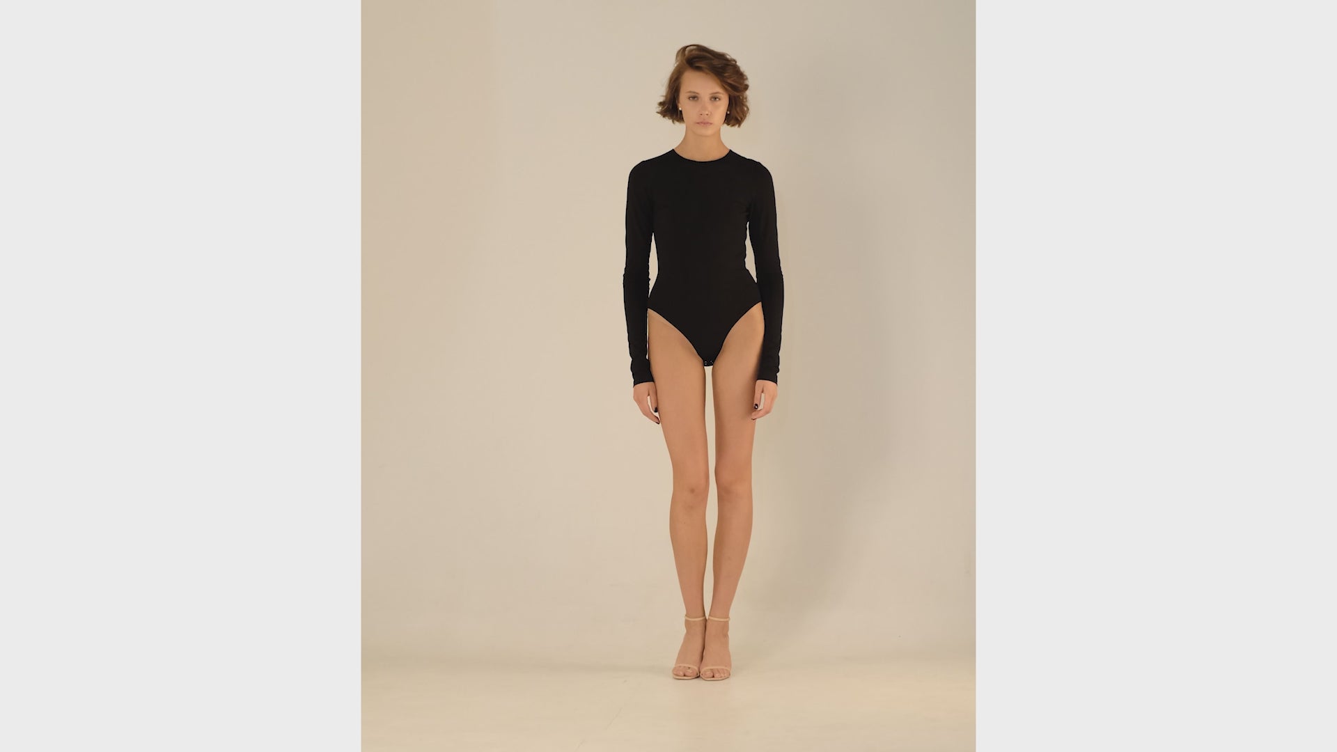 This bodysuit's model embraces femininity more than any piece of clothing possibly could. Non-transparent elastic fabric perfectly covers your body from the front and opens on the back flirtatiously.