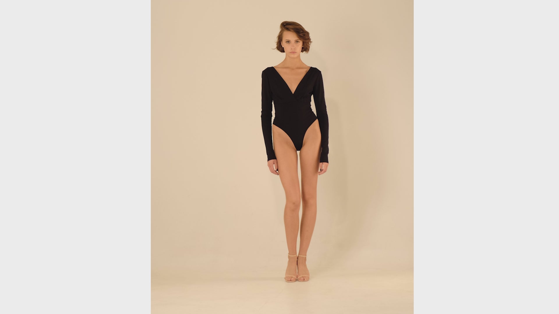 This bodysuit's model gives elegant sporty vibe. V-shape decollate and open back creates slightly provocative but very strong look.